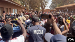 FILE - Journalists cover a political rally in August 2023 in Harare, Zimbabwe. Journalists say security officials ordered them to delete photos and video of Second Vice President Kembo Mohadi collapsing at a political rally in Gutu province on Oct. 21.