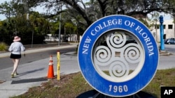 FILE - A student makes her way past the sign at New College of Florida, Jan. 20, 2023, in Sarasota, Fla. 