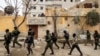 FILE - Syrian Kurdish Asayish security forces search houses during a raid against suspected Islamic State group fighters in Raqqa, Syria, Jan. 28, 2023.