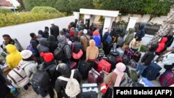FILE: Sub-Saharans at the Mali embassy in Tunis with their belongings to take a repatriation flight for their countries of origin on March 4, 2023. - Tunisia's President was accused of racism after he said "hordes" of Black Africans caused crime and posed a demographic threat.