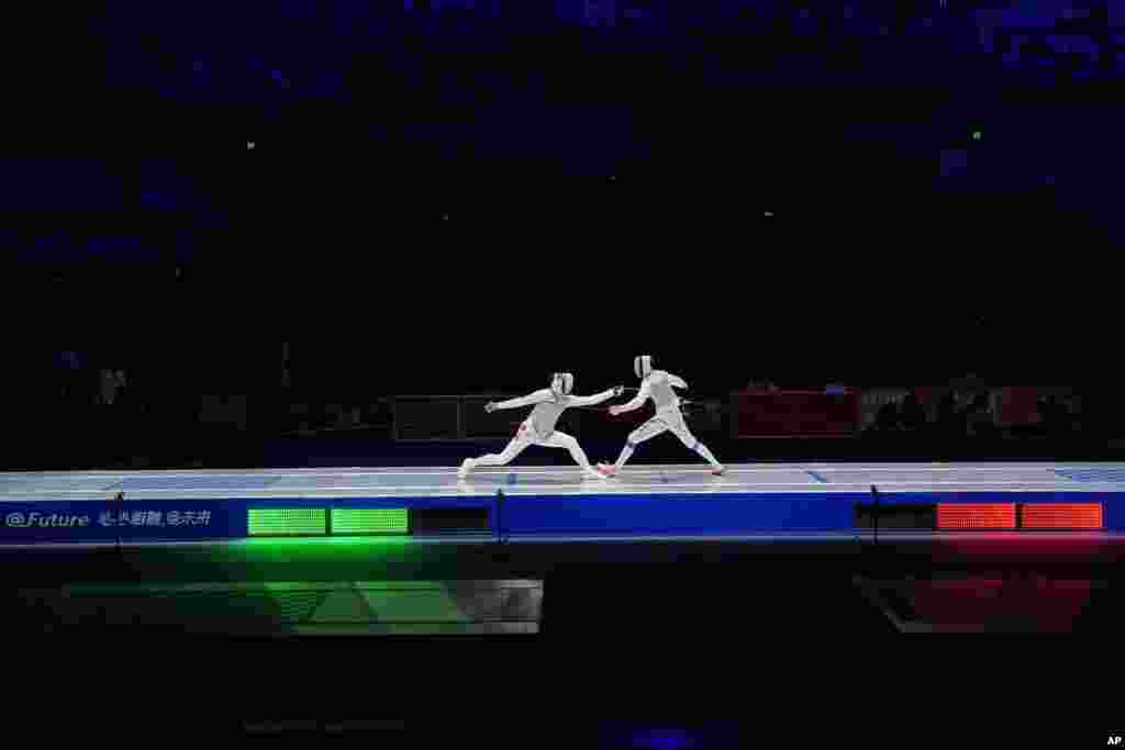 Ka Long Cheung of Hong Kong, left, competes with Haiwei Chen of China in the men&#39;s foil individual fencing final at the Hangzhou Dianzi University Gymnasium in the 19th Asian Games in Hangzhou, China.