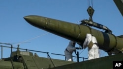 FILE - Russian troops load an Iskander missile onto a launcher during drills at an undisclosed location in Russia, in this photo released by Russian Defense Ministry Press Service, Feb. 2, 2024. Russia says it is planning to hold nuclear drills due to perceived Western threats.