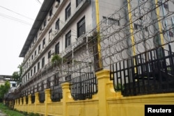 FILE - Barbed wire fences are seen outside a Great Wall Park compound where Cambodian authorities said they had recovered evidence of human trafficking, kidnapping and torture during raids on suspected cybercrime compounds in the coastal city of Sihanoukville, September 21, 2022.