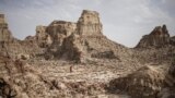 A man walks through a salt canyon, near Dallol, in the Danakil Depression of the Afar region, Ethiopia, March 24, 2024. 