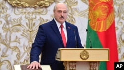 FILE - Belarusian President Alexander Lukashenko takes the oath of office at the Palace of the Independence in Minsk, Belarus, Sept. 23, 2020. Lukashenko pardoned 20 more people who rights activists describe as political prisoners, a statement on his website said on Saturday.