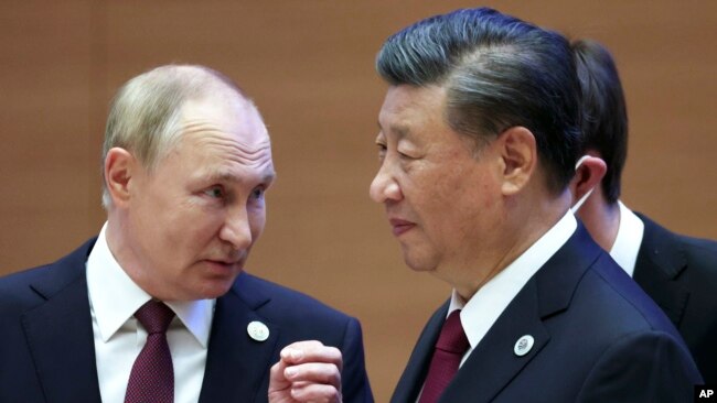 FILE - Russian President Vladimir Putin speaks with Chinese President Xi Jinping during the Shanghai Cooperation Organization summit in Samarkand, Uzbekistan, Sept. 16, 2022. (Sputnik via AP)