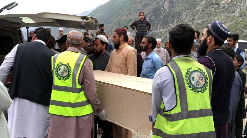 Volunteers transport the coffins of Chinese nationals from a hospital following a suicide attack in Besham city in the Shangla district of Pakistan's Khyber Pakhtunkhwa province on March 26, 2024.