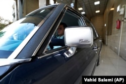 Khosro Dahaghin drives out his restored Cadillac Seville at his dealership store in Roudehen, some 30 miles (45 kilometers) east of downtown Tehran, Iran, Wednesday, June 7, 2023.(AP Photo/Vahid Salemi)