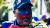 ARCHIVO - Esta imagen tomada en Caracas, Venezuela en marzo de 2020, muestra a un venezolano maquillado y con una bandera en un evento de protestas de la oposión en el país sudamericano.