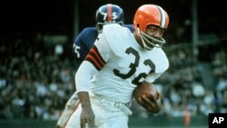 FILE - Jim Brown, Hall of Fame running back for the Cleveland Browns, is shown in action against the New York Giants in Cleveland on Nov. 14, 1965. The NFL legend, actor and social activist died at his Los Angeles home on May 18, 2023. He was 87.