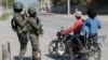 Soldiers patrol the road near the international airport in Port-au-Prince, Haiti, March 13, 2024.