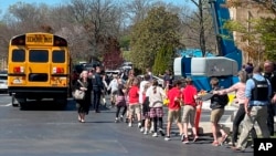 FILE - Students are taken to a reunification site after a deadly shooting at their school in Nashville, Tennessee, March 27, 2023. The United States is setting a record pace for mass killings in 2023, with an average of one every 6.53 days, according to a data analysis.