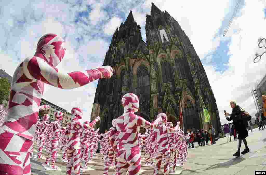 Детски манекени во виолетова и бела лента за барикада поставени пред катедралата во Келн, поставена од германскиот уметник Денис Јозеф Месег, наречена &bdquo;Раскршени души - во морето на тишината&ldquo;, во знак на протест против скандалите со злоупотреба во католичката Црква во Келн, Германија.