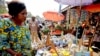 FILE - A woman shops at the Mvog Ada market in Yaounde, Cameroon, Jan. 29, 2022. 