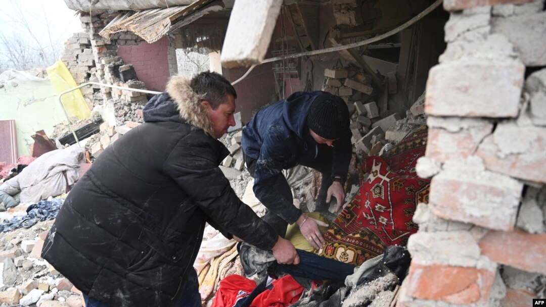 People search the rubble of a house following a Russian strike in the village of Velyka Vilshanytsia, some 50 km from Lviv, Ukraine, on March 9, 2023. 