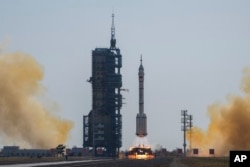 A Long March rocket carrying a crew of Chinese astronauts in a Shenzhou-17 spaceship lifts off at the Jiuquan Satellite Launch Center in northwestern China, Oct. 26, 2023.