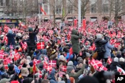 People try to get a view as Denmark's Crown Prince Frederik arrives at Christiansborg Palace in Copenhagen, Jan. 14, 2024.