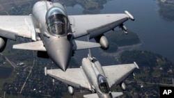 FILE - Italian Air Force Eurofighter Typhoon military fighter jets participate in NATO's Baltic Air Policing Mission operate in Lithuanian airspace, on Sept.12, 2023.