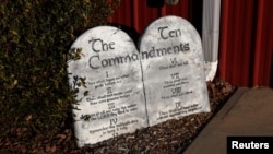 FILE - Tablets bearing the Ten Commandments sit outside a polling station at Piedmont Wesleyan Church in Piedmont, South Carolina, during a primary, Feb. 3, 2024. Louisiana is the first U.S. state requiring the Ten Commandments be displayed in every public school classroom.