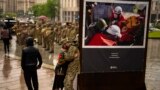 An army comrade is comforted as he cries during the funeral ceremony of Ukrainian army paramedic Nazarii Lavrovskyi, 31, killed in the war, at Independence square in Kyiv, April 24, 2024.