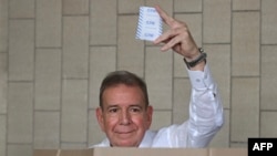 FILE: Venezuelan opposition presidential candidate Edmundo Gonzalez Urrutia shows his ballot as he votes at the Santo Tomas de Villanueva school in Caracas during the presidential election on July 28, 2024.