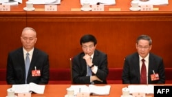 中共中央書記處書記蔡奇（左）、全國政協主席王滬寧（中）與國務院總理李強在中國人民大會堂出席全國人大會議。（2023年3月7日）