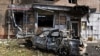 A burned car is seen in front of an apartment building damaged after shelling by the Ukrainian side in Kursk, Russia, Aug. 11, 2024. 