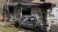 A burned car is seen in front of an apartment building damaged after shelling by the Ukrainian side in Kursk, Russia, Aug. 11, 2024. 