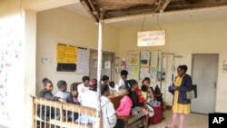 Barbara Nabulo talks to patients at the children's emergency ward at Mbale Regional Referral Hospital in Mbale, Uganda, April 26, 2024. 
