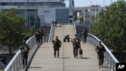 Soldiers patrol on a footbridge over the Seine River in Paris, July 17, 2024.