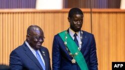 FILE—Bassirou Diomaye Faye (C) and President of Ghana, Nana Akufo-Addo (L) pose for images after his swearing in as Senegal's President at an exhibition center in the new town of Diamniadio near the capital Dakar on April 2, 2024.