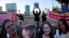 Demonstrators block the main highway as they hold signs with the faces of female hostages held in Gaza since October 7 and to call for their immediate release, in Tel Aviv, Israel.