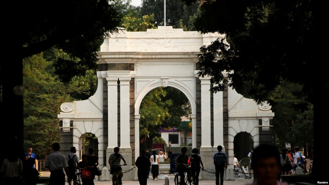 FILE = People walk near the gate of Tsinghua University in Beijing, July 27, 2016. 