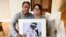 FILE - Derek and Suzi Alkonis pose with a photo of their son, Lt. Ridge Alkonis, in Dana Point, California, June 1, 2022.
