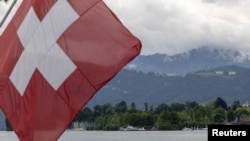 A Swiss flag is pictured in front of the Burgenstock Resort where the Summit on Peace in Ukraine will take place June 15 and 16, in Lucerne, Switzerland, May 28, 2024. 