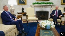 FILE - Speaker of the House Kevin McCarthy of Calif., left, listens as President Joe Biden speaks about the debt limit in the Oval Office, May 9, 2023, in Washington.