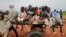 FILE - Sudanese children, who fled the conflict in Murnei in Sudan's Darfur region, ride a cart while crossing the border between Sudan and Chad in Adre, Chad, Aug. 4, 2023.