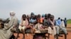 FILE - Sudanese children who fled the conflict in Murnei in Sudan's Darfur region ride a cart while crossing the border between Sudan and Chad in Adre, Chad, Aug. 4, 2023.