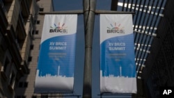 FILE - Banners promoting a BRICS summit hang from a pole outside the Sandton Convention Centre in Johannesburg, South Africa, Aug. 19, 2023. 
