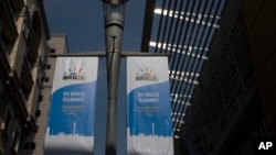 Banners for the upcoming BRICS summit hang from a pole outside the Sandton Convention Centre in Johannesburg, South Africa, Aug. 19, 2023. 