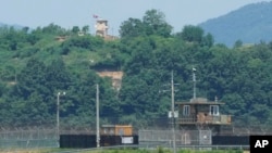 A North Korean military guard post, top, and South Korean post, bottom, are seen from Paju, South Korea, near the border with North Korea, May 31, 2024. 