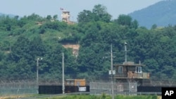 A North Korean military guard post, top, and South Korean post, bottom, are seen from Paju, South Korea, near the border with North Korea, May 31, 2024.