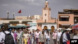 FILE - Tourists walk about in Jemaa el-Fnaa square in Morocco's Marrakesh on May 12, 2022.