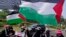 Indonesian Muslim women wave Palestinian flags during a rally in support of Palestinians, in Jakarta, Indonesia, Oct. 13, 2023. 