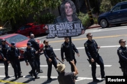 FILE - Local residents protest the Biden administration's support of Israel amid the conflict between Israel and Hamas as U.S. Vice President Kamala Harris arrives in Oakland, Calif., June 5, 2024.