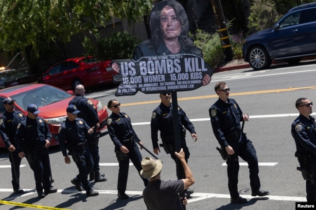 FILE - Local residents protest the Biden administration's support of Israel amid the conflict between Israel and Hamas as U.S. Vice President Kamala Harris arrives in Oakland, Calif., June 5, 2024.