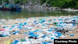 Plastic bags line a beach in Dong Hoa, Vietnam. (Greenhub/Ocean Conservancy)
