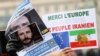 People hold pictures of Belgian aid worker Olivier Vandecasteele during a protest against his detention in Iran, in Brussels, Jan. 22, 2023.