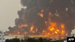 A handout picture obtained from Yemen's Huthi Ansarullah Media Center shows a huge column of fire erupting following strikes in the Yemeni rebel-held port city of Hodeidah on July 20, 2024. 