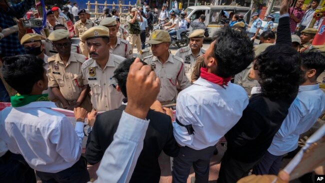 Policemen stand guard as students protest against the Citizenship Amendment Act (CAA) in Guwahati, India, Tuesday, March 12, 2024. (AP Photo/Anupam Nath)